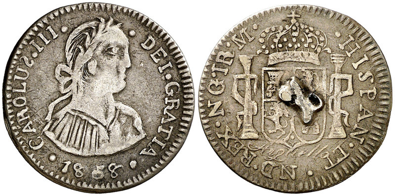 Botón de plata reproduciendo 1 real de Guatemala a nombre de Carlos III. 2,91 g....