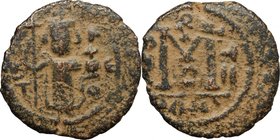 Arab-byzantine, Umayyad Caliphate, pre-reform coinage. AE Fals, Emesa mint, 41-77 H / 661-697 AD. D/ Byzantine emperor standing, holding globus crucig...