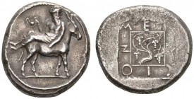 CLASSICAL COINS 
 MACEDONIA 
 MENDE 
 Tetradrachm, about 425 BC. AR 17.03 g. Dionysos, wearing himation, nude to waist, seated l. on the back of a ...