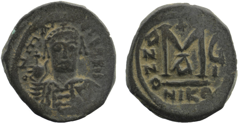 Maurice Tiberius. 582-602. AE Follis 
helmeted and cuirassed bust facing holding...