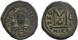 Maurice Tiberius. 582-602. AE Follis 
helmeted and cuirassed bust facing holding globus cruciger and shield 
Rev: Large M between A / N / N / O above,...