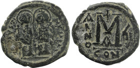 Justin II & Sophia AE Follis Constantinople 565 AD
Justin on left holding cross on globe and Sophia on right, holding sceptre topped by cross, both ni...