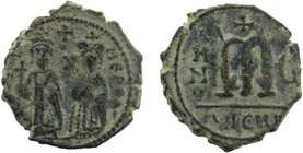 Phocas. 602-610. AE follis
Phocas on left and Leontia on right, standing facing; he holds a globus cruciger while she holds a cruciform scepter, cross...