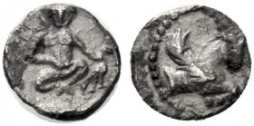 Greek Coins   The Coinage of Samaria  Half ma‘eh / hemiobol mid 4th century BC, AR 0.23 g. Nude youth, seated facing on ground, soles of feet parallel...
