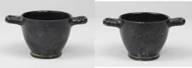 Campanian Blackware Skyphos.
 With pedestal foot, loop handles to the rim.
 4th-3rd century BC.
 H. 7.4 cm.