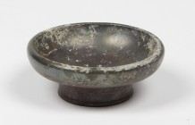 Greek black-glazed miniature cup.
 4th century BC.
 8.5 cm diameter; 3 cm height.