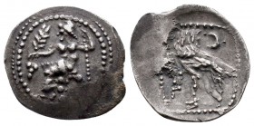 Cilicia, uncertain mint AR Obol. 4th century BC. Baaltars seated left, holding grain ear, grapes and sceptre / Forepart of wolf right; crescent above....