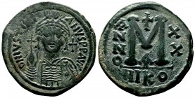 Justinian I the Great (AD 527-565). AE follis. Constantinople, RY 20. Helmeted and cuirassed bust of Justinian facing, holding globus cruciger and shi...