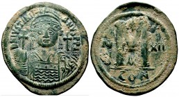 Justinian I the Great (AD 527-565). AE follis . Constantinople, RY 12 (AD 538/9). Helmeted and cuirassed bust of Justinian facing, holding globus cruc...