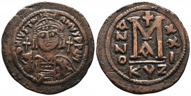 Justinian I the Great (AD 527-565). AE follis . Constantinople, RY 21. Helmeted and cuirassed bust of Justinian facing, holding globus cruciger and sh...