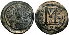 Justinian I the Great (AD 527-565). AE follis . Constantinople, RY 12 (AD 538/9). Helmeted and cuirassed bust of Justinian facing, holding globus cruc...