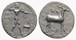 Bruttium, Kaulonia, c. 475-425 BC. AR Stater (21mm, 7.81g, 60h). Nude Apollo walking r., holding branch, holding small running daimon on outstretched ...