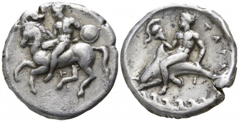 Calabria. Tarentum 344-340 BC.
Nomos AR

21mm., 7,65g.

Warrior, holding ro...