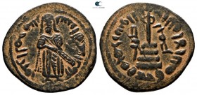 Time of `Abd al-Malik ibn Marwan AD 685-705. (AH 65-86). 'Standing Caliph' type. Struck circa AD 690s. Hims (Emesa) mint. Fals Æ