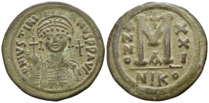 Justinian I. AD 527-565. Nikomedia
Follis Æ

37mm., 18,28g.

Helmeted, drap...