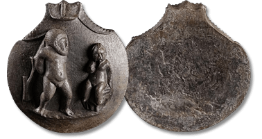 Lot 1. A Roman bronze attachment with Eros binding Hercules. Circa 1st-2nd century AD.