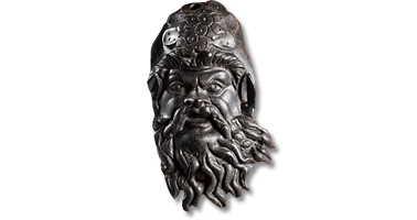 Lot 5. A large and expressive Roman bronze applique of Silenus. Circa 1st century AD.